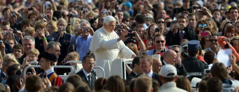 Benedict waves to pilgrims as he arrives at St. Peter's Square for his weekly address in October 2012.