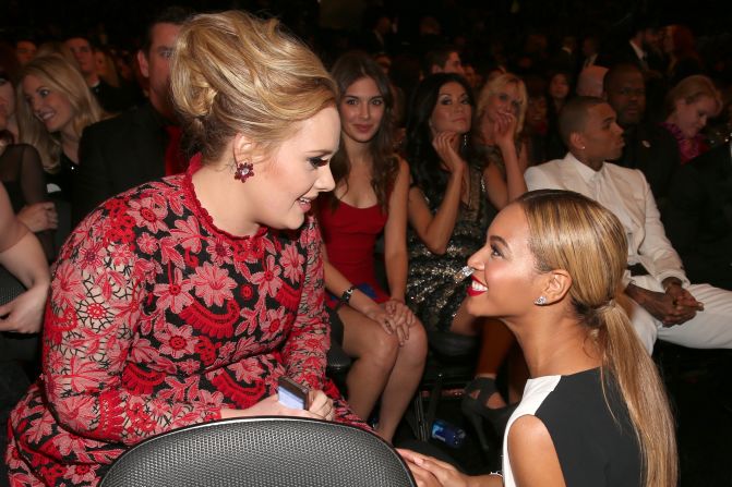 Beyonce: "Do you see that girl in the red trying to photobomb us right now?!"<br />Adele: "Bey, I do! Just ignore her and smile."