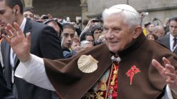 Pope Benedict XVI waves to faithful as he wears a pilgrim cape with a scallop shell and a Santiago cross embroidered on it during his visit in Santiago de Compostela, on November 6, 2010. Benedict XVI lands in Spain today to reclaim a bastion of the Church from the lure of quick divorce, abortion rights and gay marriage. AFP PHOTO/ POOL/ LAVANDEIRA JR (Photo credit should read Lavandeira jr/AFP/Getty Images)
