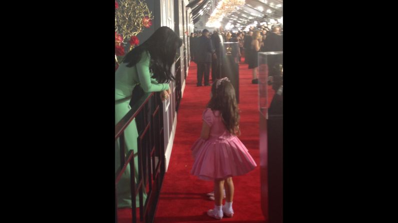 Katy Perry planned to race past the press like her BFF Rihanna, but couldn't resist stopping for a little girl talk with "The Ellen Degeneres Show's" pink princesses Sophia Grace and Rosie (obscured in photo). What do you think they're talking about?