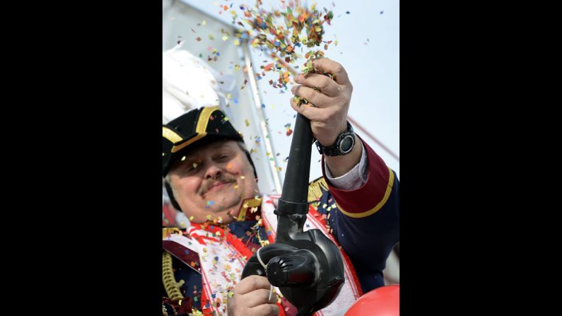 A man shoots confetti in the air at the carnival in Herbstein. 