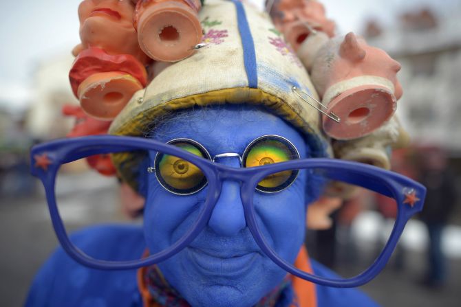 A blue attendee shows off his costume at the Springerzug carnival parade in Herbstein, Germany. The Springerzug, literally "jumping parade," is an interpretation of carnival tradition particular to Herbstein. 