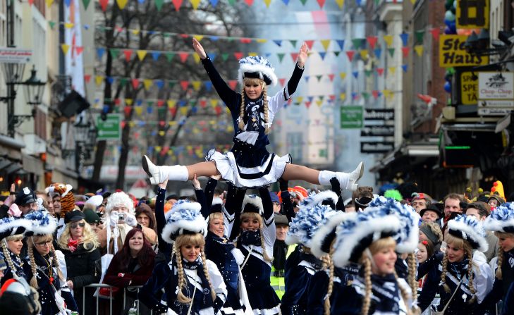 A performer is lifted into the air during the Rose Monday parade in Düsseldorf.