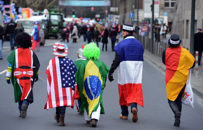People wearing flags walk in the streets of Düsseldorf.