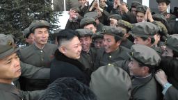 This picture taken by North Korea's official Korean Central News Agency (KCNA) on December 12, 2012 shows North Korean leader Kim Jong-Un (lower L) celebrating with staffs from the satellite control center during the launch of the Unha-3 rocket, carrying the satellite Kwangmyongsong-3, at the general satellite control and command center in Pyongyang. 