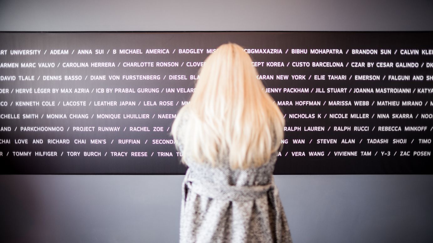 A guest looks at the designer board in the lobby of the Lincoln Center at New York Fashion Week on Tuesday, February 12. 
