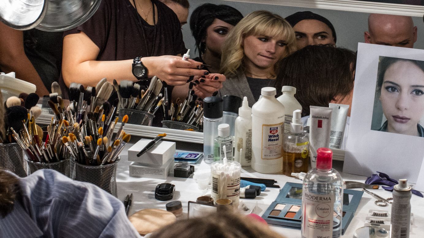 Makeup professionals pick up tips from visiting makeup artists backstage on February 12.
