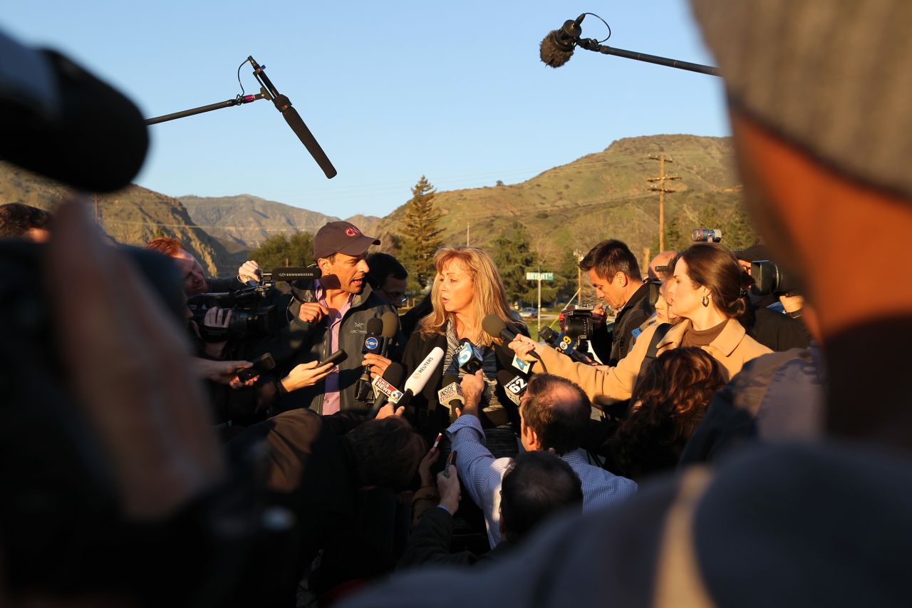 Cindy Bachman, information officers for the San Bernardino County Sheriff's Department, speaks to reporters at a roadblock near Big Bear Lake, California, on Tuesday, February 12. Christopher Jordan Dorner has been the subject of a massive manhunt and is accused of killing one police officer and wounding two others, as well as killing the daughter of his police union representative and her fiance on Sunday.