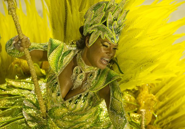 More than 500,000 foreign visitors flock to the carnival each year to dance, shout, drink and surge around in happy mobs, watching dancers like this one of Vila Isabel samba school.