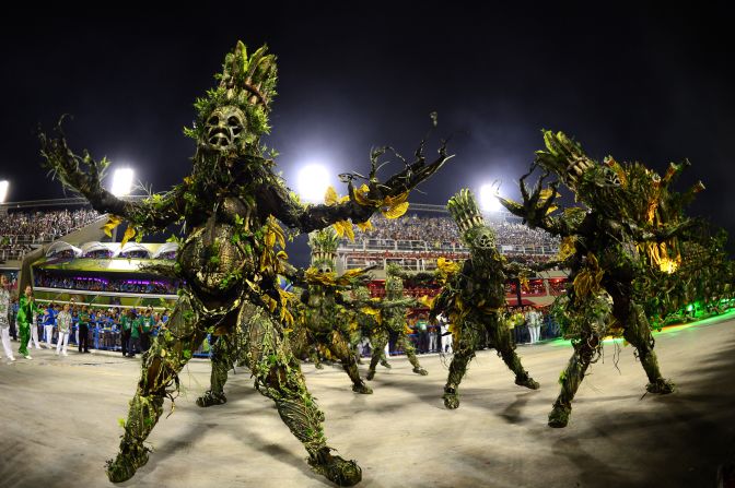 Imperatriz Leopoldinense samba school perform wearing elaborate costumes during Carnival parades at the Sambadrome.