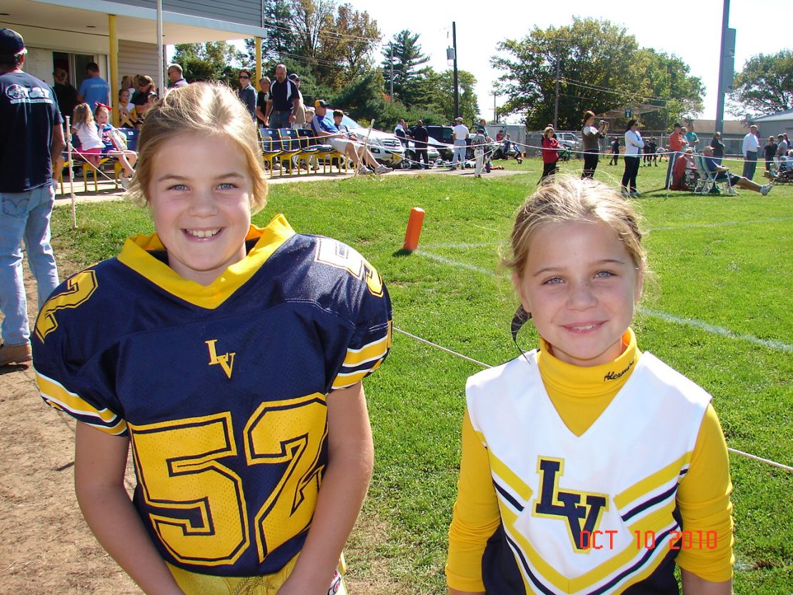 Alexandra, 11, a cheerleader, likes to watch her twin sister play and wants the rule changed.