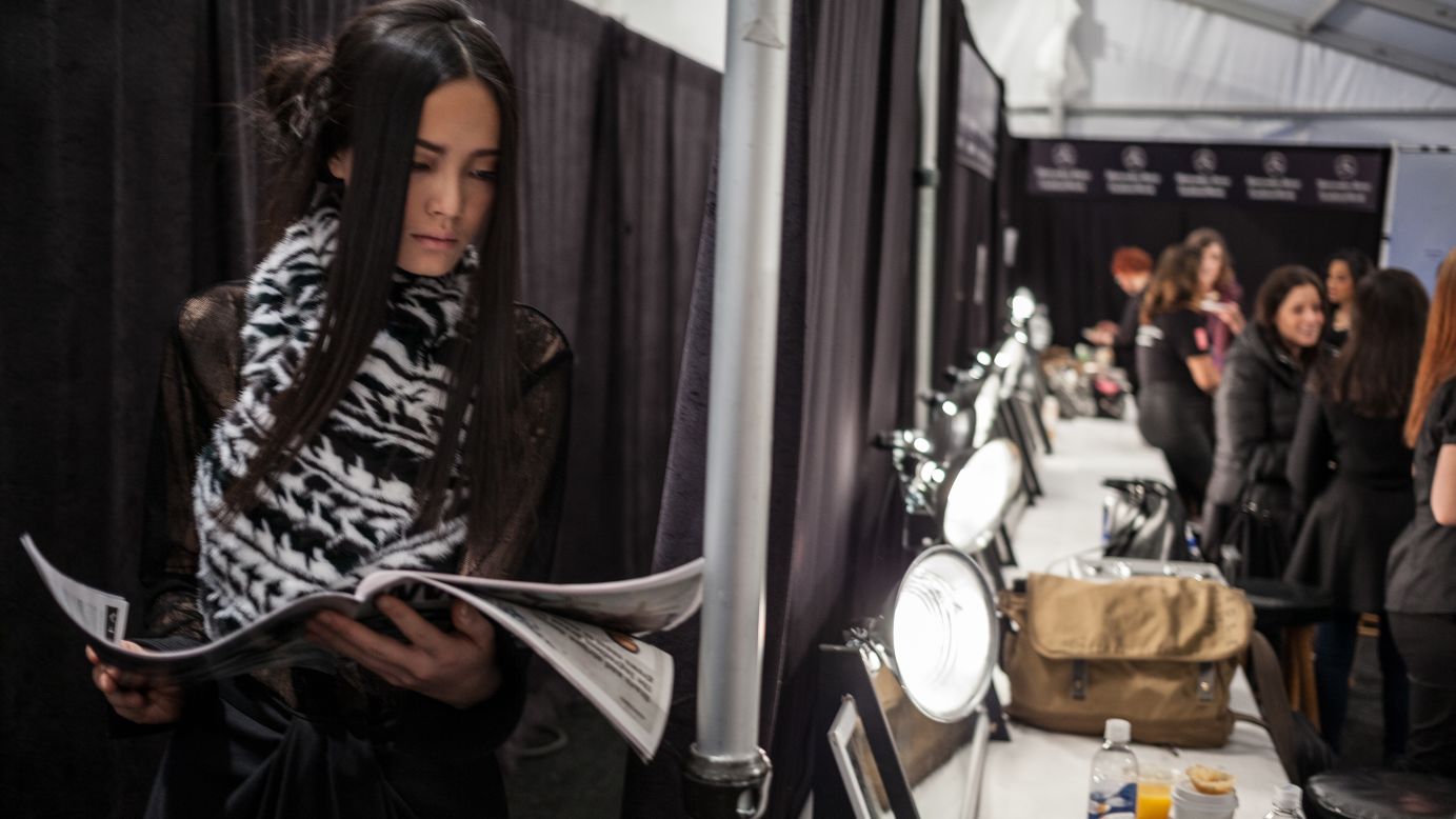 A model reads backstage at the Brandon Sun show on February 13.