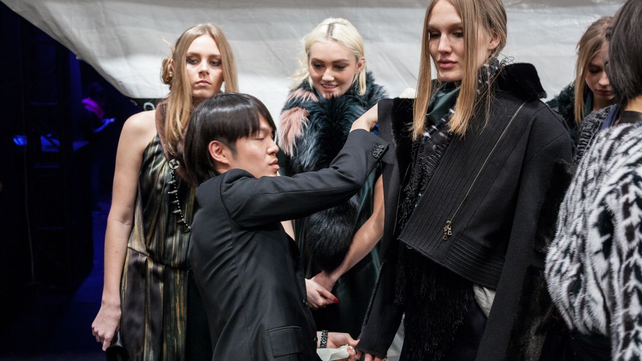 Designer Brandon Sun preps models backstage during his show. Sun launched his first collection of luxury fur accessories in 2011.