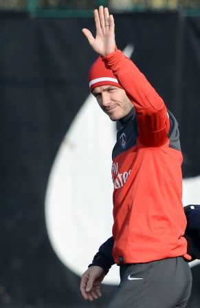 Beckham waves to the waiting press pack as he makes his way out at the club's Camp des Loges training center in Saint-Germain-en-Laye, near Paris. The session, which was led by PSG's Italian coach Carlo Ancelotti, was shown live on French television.