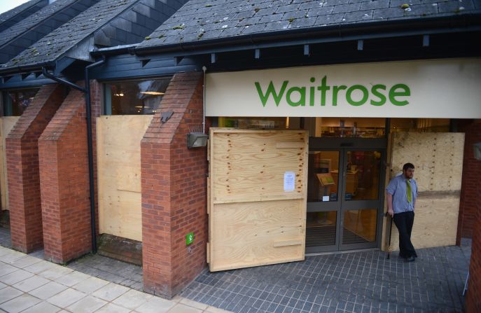 Shops are boarded up before rival teams the 'Up'ards and Down'ards' battle for the ball .