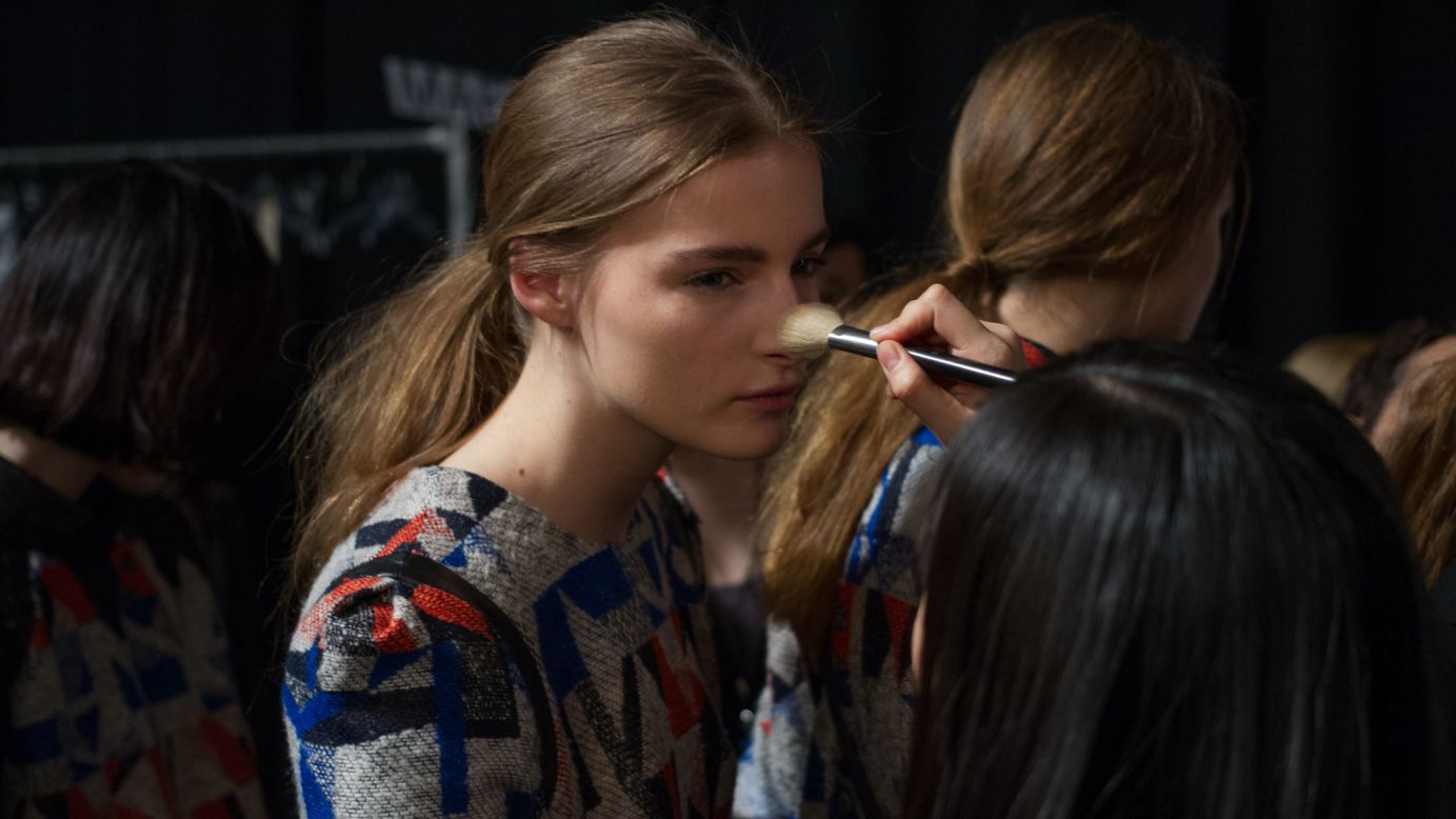 A model gets a touchup before hitting the runway on February 13.
