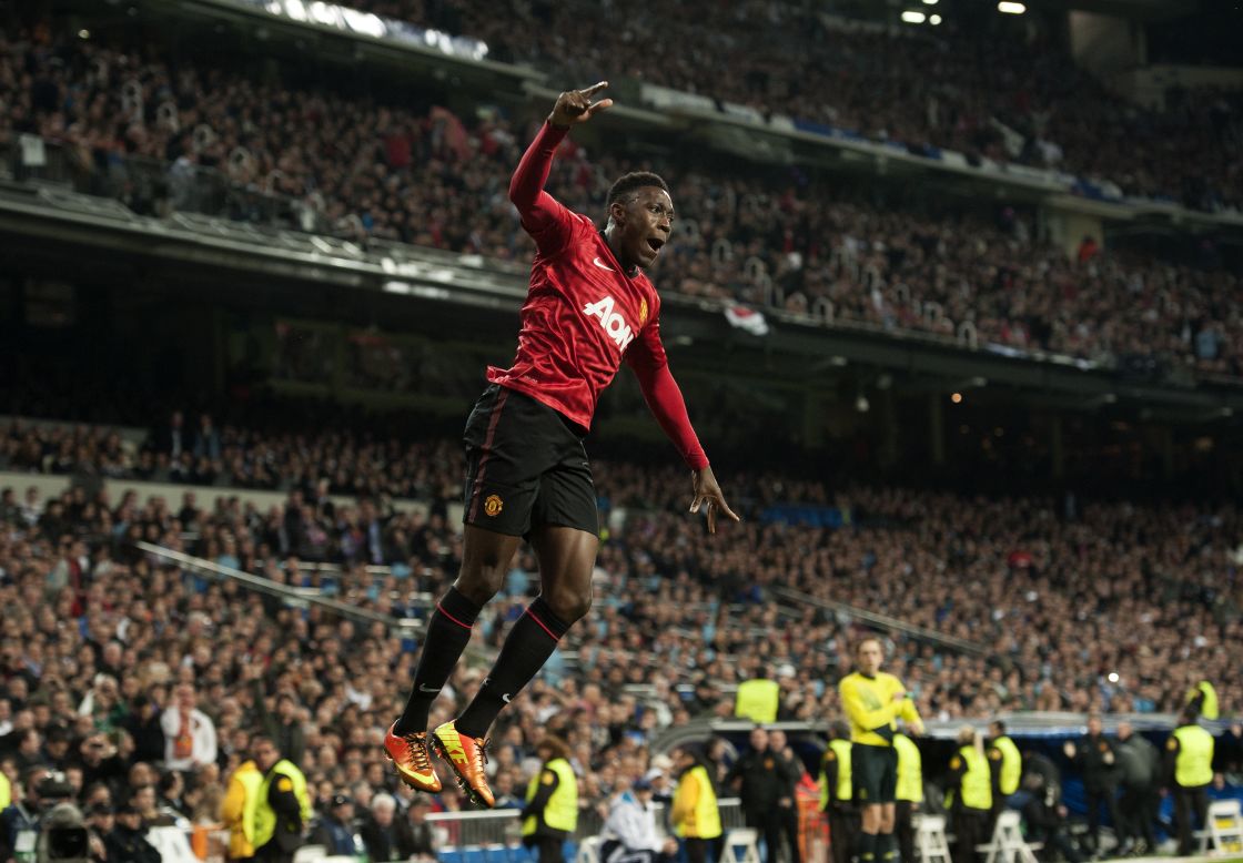 Welbeck dances away in celebration after firing United ahead, while most of the crowd look on in stunned silence. 