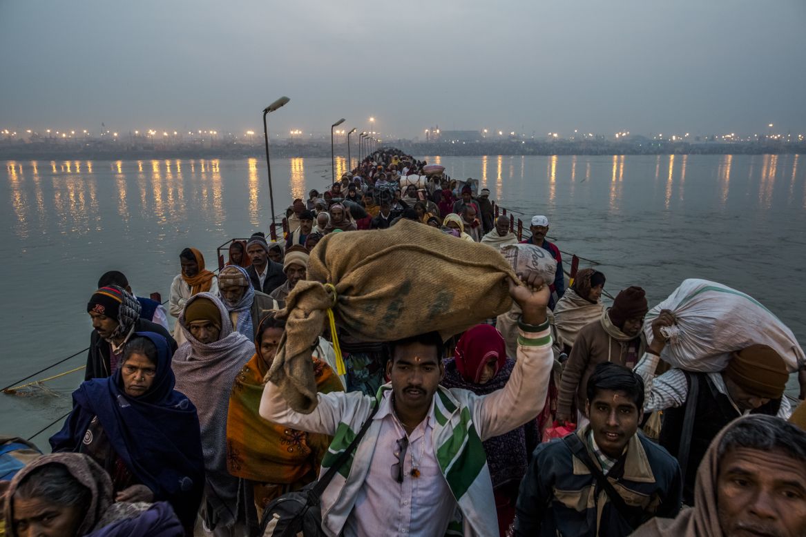 Hindu pilgrims walk across a pontoon bridge on the banks of Sangam on Tuesday, February 12, at the confluence of the rivers Ganges, Yamuna and the mythical Saraswati.