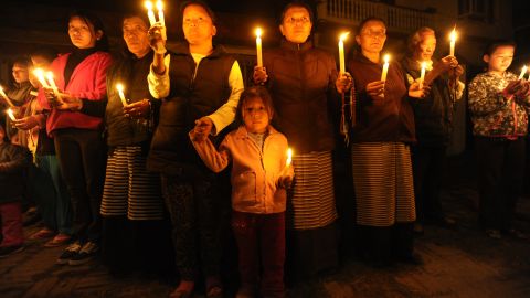 Tibetans-in-exile hold a candlelight vigil following the self-immolation attempt by a monk in Kathmandu on February 13, 2013.