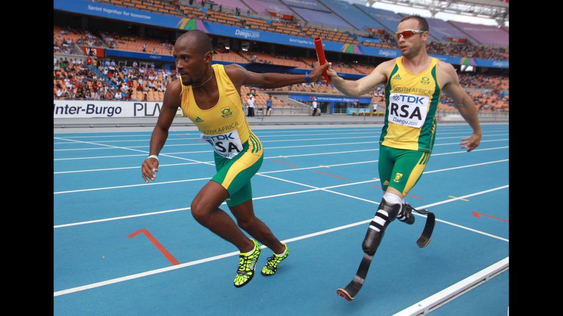 Pistorius passes the baton to Ofentse Mogawane in a 4x400-meter relay race during the IAAF World Athletics Championships in Daegu, South Korea, in September 2011. Pistorius was the first double-amputee athlete to compete at the World Athletics Championships.