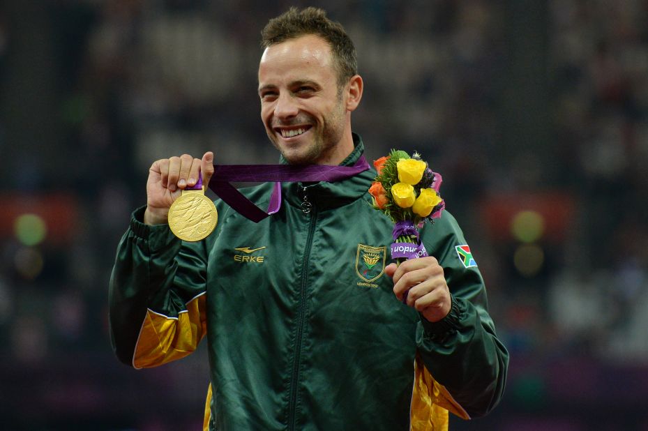 Pistorius poses on the podium with his gold medal after winning the men's 400-meter T44 final at the 2012 Paralympic Games. 