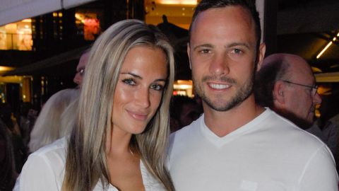 A picture taken on January 26, 2013, shows Olympian sprinter Oscar Pistorius posing next to his girlfriend Reeva Steenkamp.