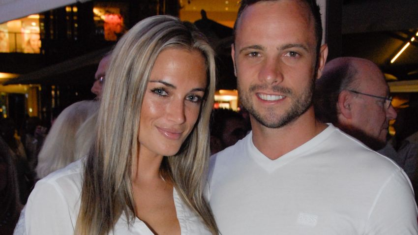 A picture taken on January 26, 2013 shows Olympian sprinter Oscar Pistorius posing next to his girlfriend  Reeva Steenkamp at Melrose Arch in Johannesburg. South Africa's Olympic sprinter Oscar "Blade Runner" Pistorius was taken into police custody on February 14, 2013, after allegedly shooting dead his model girlfriend having mistaken her for an intruder at his upscale home. AFP PHOTO / WALDO SWIEGERS        (Photo credit should read WALDO SWIEGERS/AFP/Getty Images)
