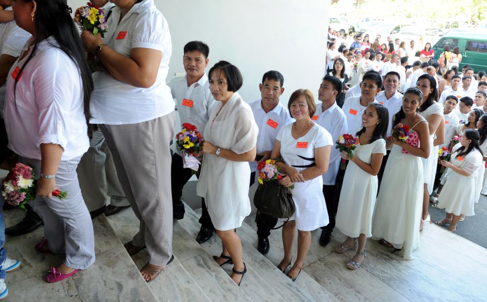 Hundreds of couples wait in line for a mass Valentine's Day wedding in Manila, Philippines.