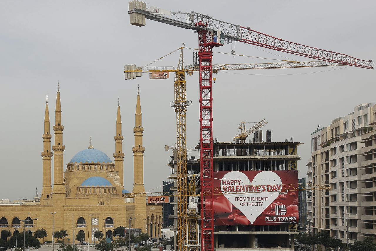 A giant Valentine's Day poster hangs on a construction site near a mosque in Beirut, Lebanon.  