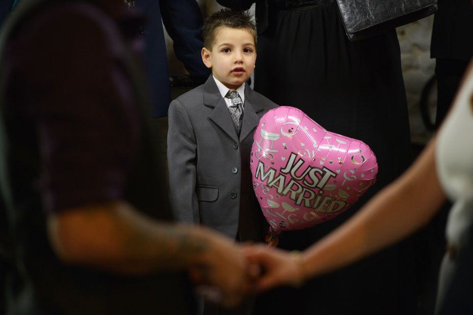 A boy holds a balloon as he attends a wedding at Gretna Green in Dumfries and Galloway, Scotland. Gretna Green has been hosting weddings since 1754 and is a popular destination for Valentine's Day weddings. 