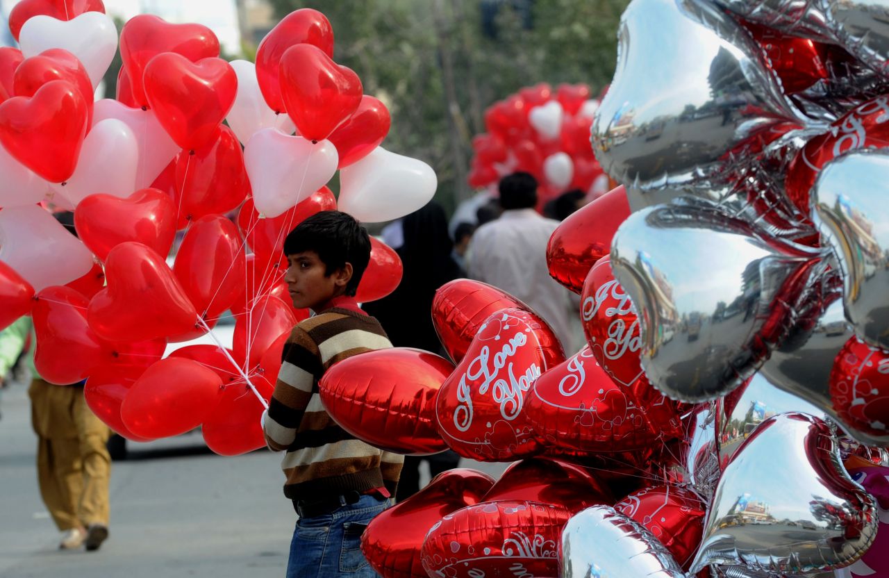 A vendor sells heart-shaped Valentine's Day balloons in Lahore, Pakistan.