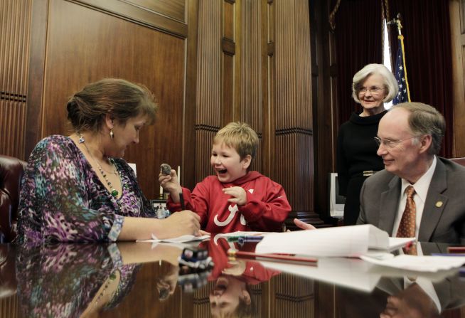 Five-year-old Ethan, who was held captive in an underground bunker for nearly a week by Jimmy Lee Dykes, and his mother Jennifer Kirkland visit with Alabama Gov. Robert Bentley in the governor's office on Wednesday, February 13.