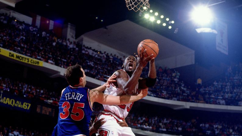 Jordan shoots a layup against Danny Ferry of the Cleveland Cavaliers during a game in 1991.