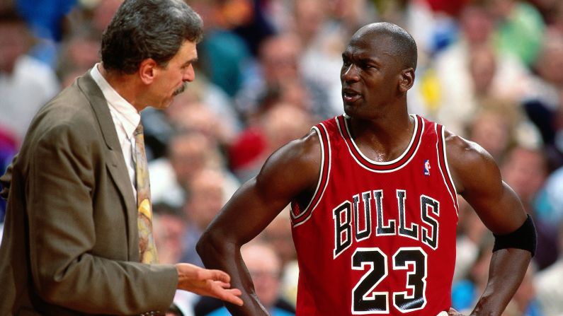 Jordan and former Bulls head coach Phil Jackson talk during a game in 1991.