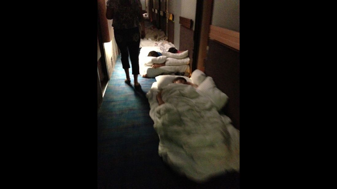 Passengers lie on mattresses in a hallway aboard the Carnival Triumph. 