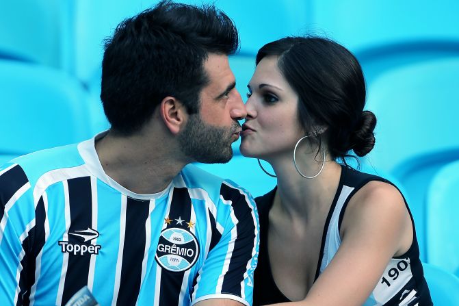 A couple kisses on Valentine's Day before the soccer match between Gremio of Brazil and Huachipato of Chile for the Libertadores Cup, in Porto Alegre, Brazil.