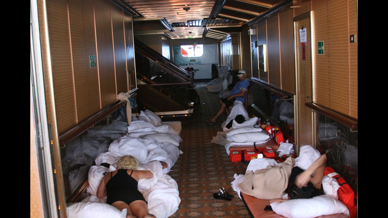 Passengers lie on beds in a hallway aboard the Carnival Triumph.