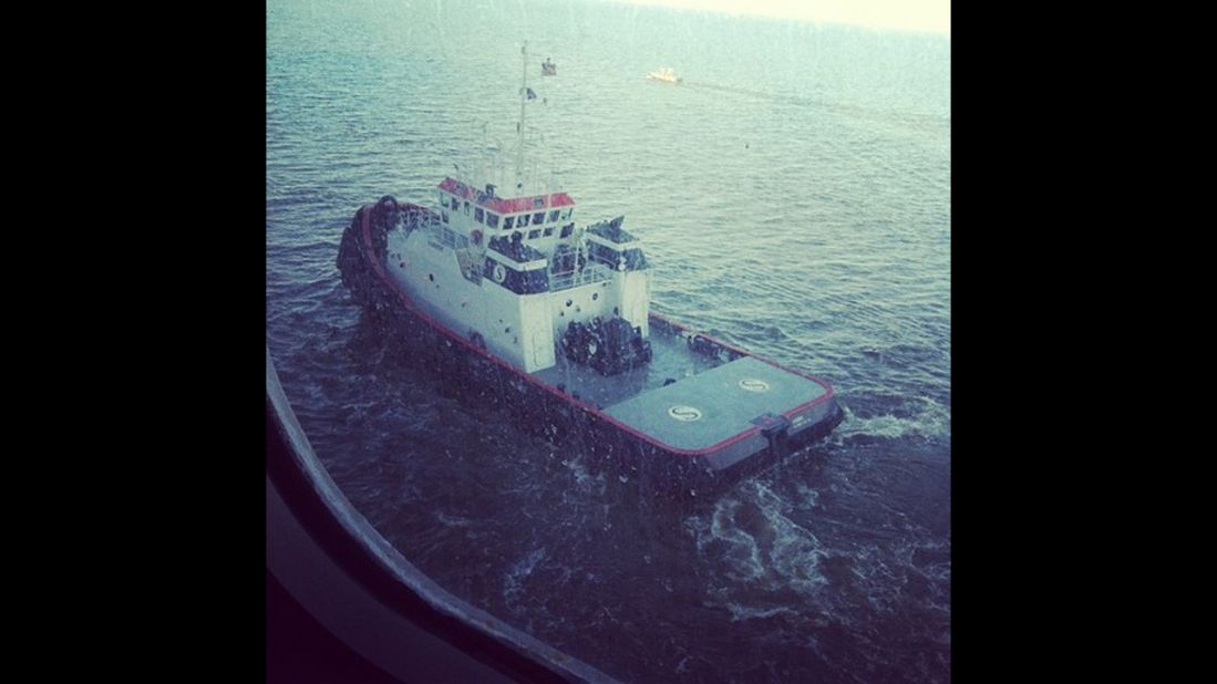 "One of two tugboats pulling us through the channel to Mobile, Alabama, along with a channel guide boat," writes Maclaskey. The ship is being towed slowly to Mobile, Alabama, and is expected to port late February 14.