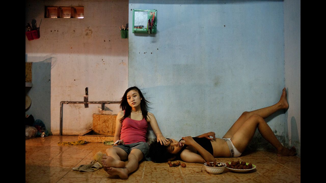 <strong>First prize -- contemporary issues stories:</strong><br />Phan Thi Thuy Vy and Dang Thi Bich Bay watch TV after studying on June 22, 2012, in Da Nang, Vietnam. The couple have been together for a year, according to photographer Maika Elan, in a country that's been hostile to same-sex relationships in the past.