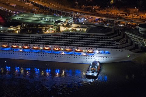 The crippled cruise liner Carnival Triumph limps into port late Thursday, February 14, in Mobile, Alabama. Passengers had endured five days aboard the stricken ship with little power and few toilet facilities after a fire knocked out propulsion and other systems on Sunday, February 10. 