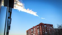 (File) The trail of a falling object is seen above a residential apartment block in the Urals city of Chelyabinsk.