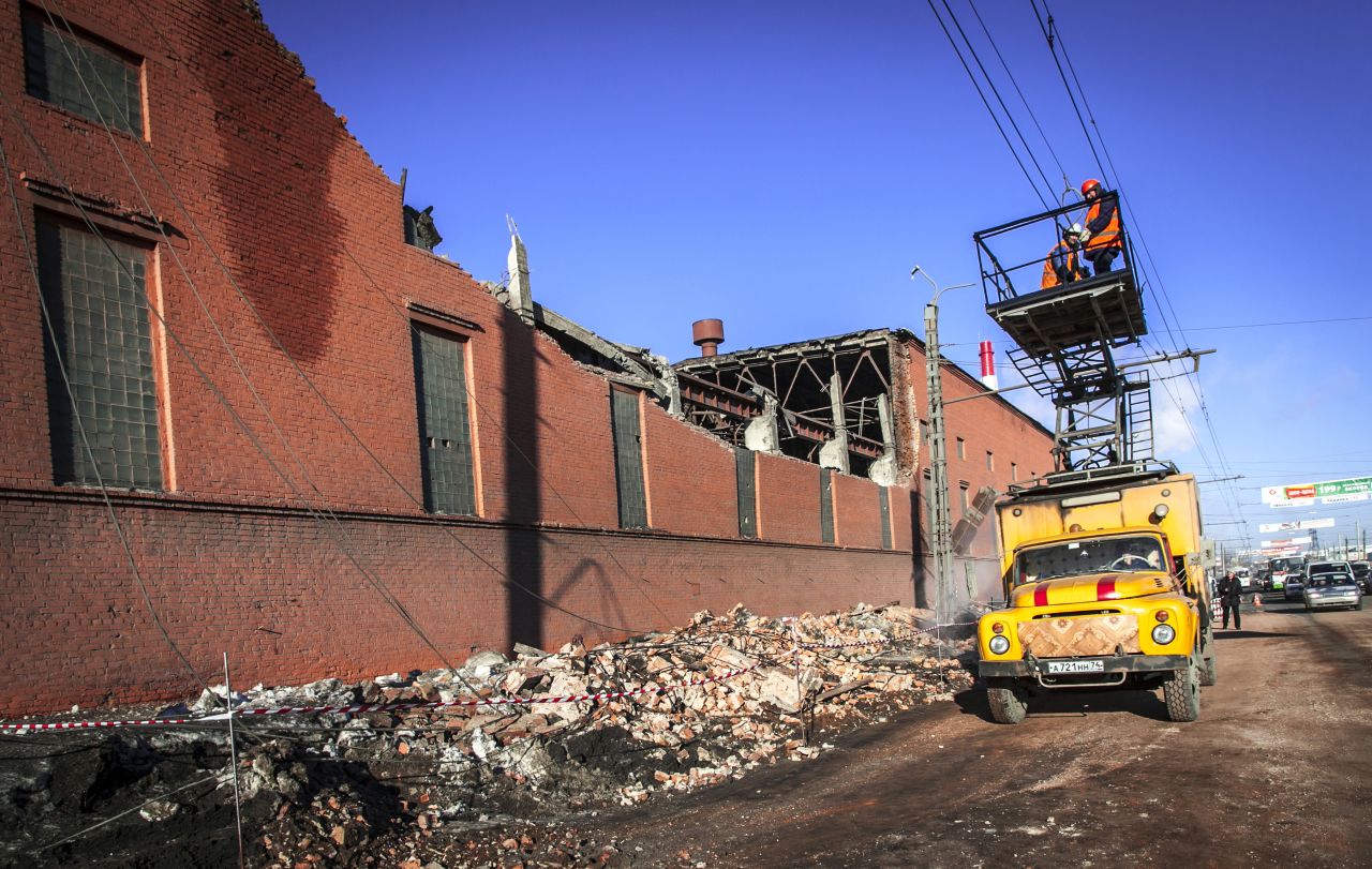 Workers repair a damaged power line near the wall of a local zinc plant. About 270 buildings were damaged -- mostly broken glass -- by shock waves caused by the blast, said Vladimir Stepanov of the National Center for Emergency Situations at the Russian Interior Ministry.