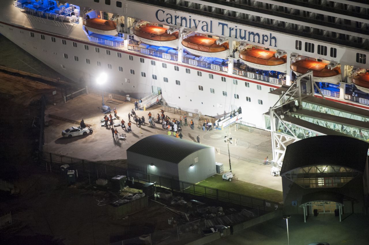 Members of the media wait for the last passengers to disembark the ship. 
