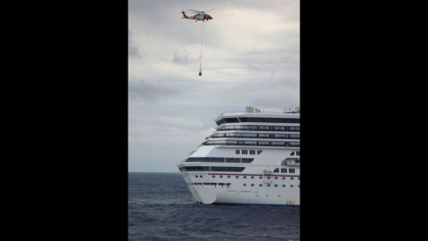 A U.S. Coast Guard helicopter delivers equipment, including a generator and electrical cables, to the Triumph on Wednesday, February 13, in the Gulf of Mexico. 
