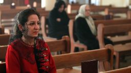 A woman attends Mass at a Chaldean church in Baghdad four years ago. Many Iraqi Christians have fled Iraq because of war and persecution.