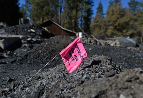 An evidence flag placed by San Bernardino County Sheriff's crime scene investigators sits on pile of rubble in the burned cabin on February 15.