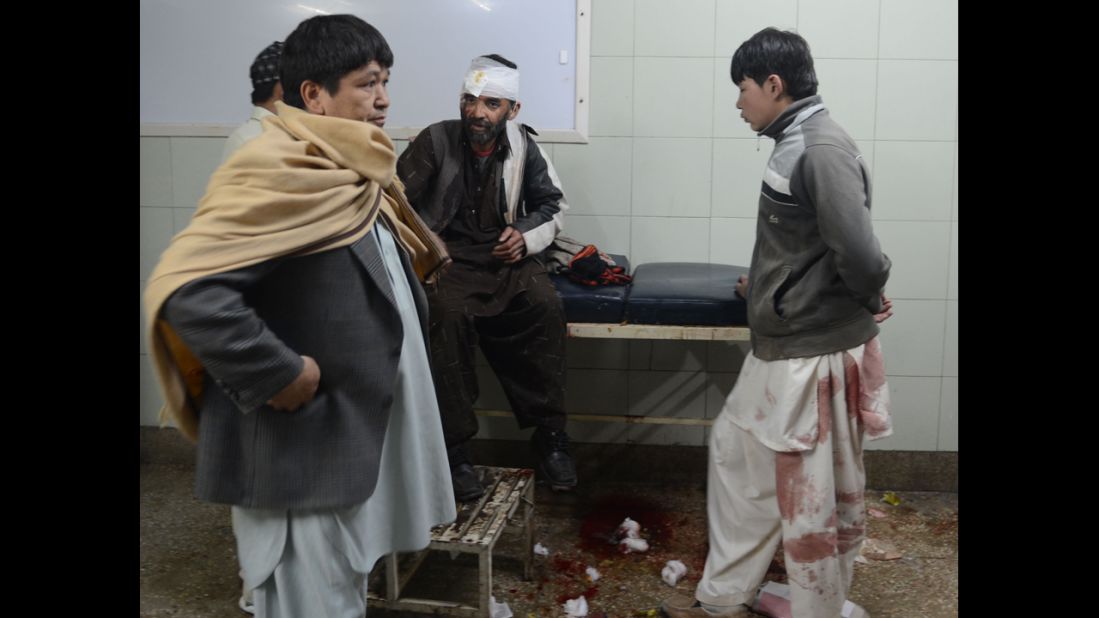 Relatives gather around an injured victim at a hospital in Quetta.