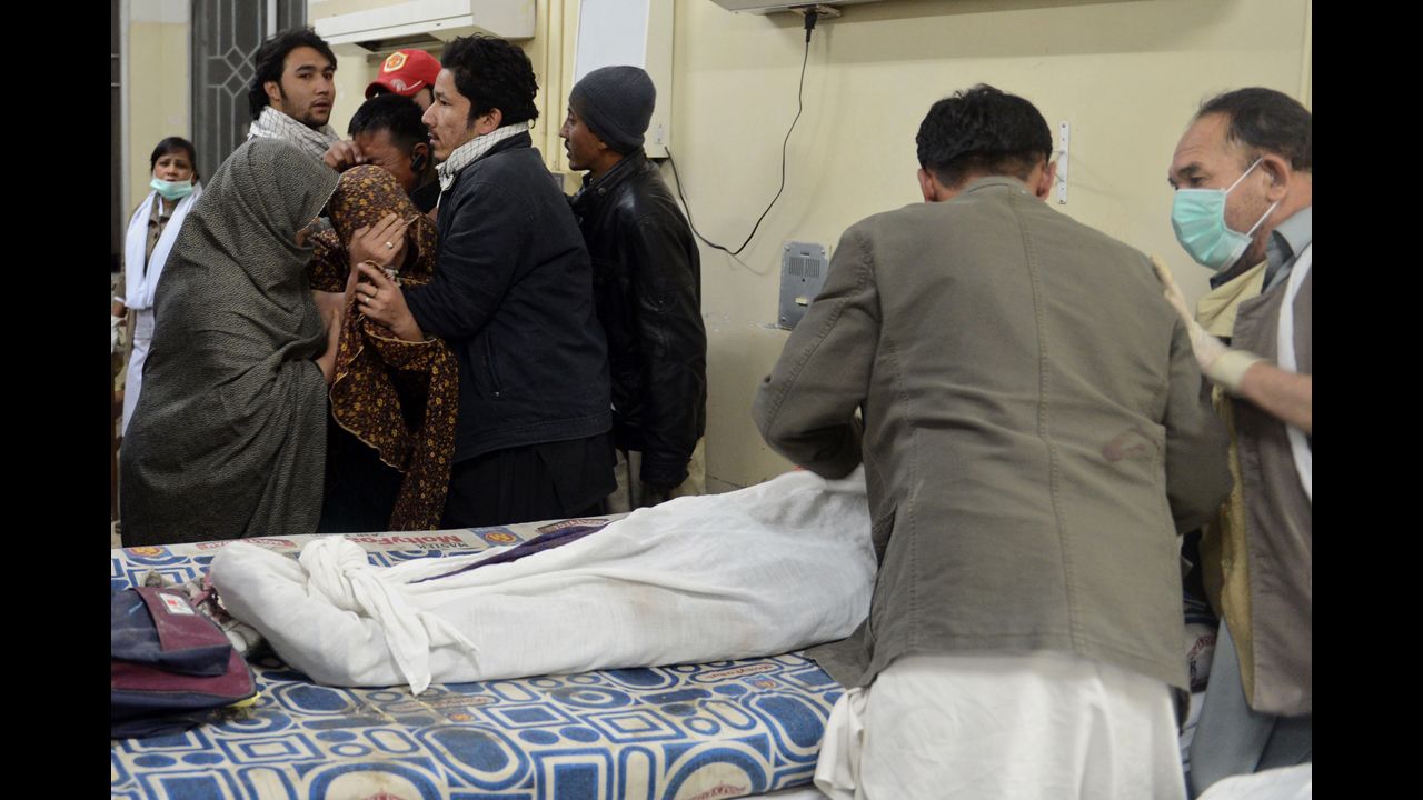 Mourners stand near a relative killed in the blast. 