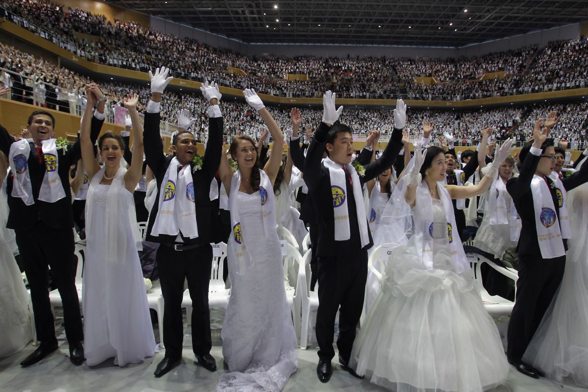 Couples cheer during the wedding ceremony. 