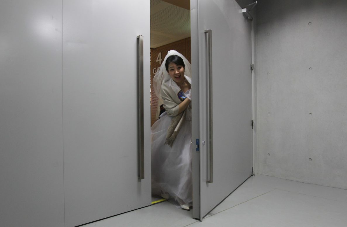 A bride passes through a door at the center.